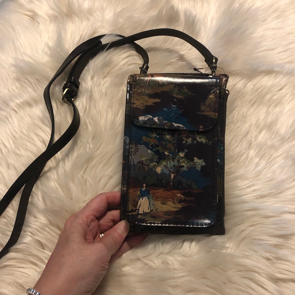 Patricia Nash wallet on a strap.